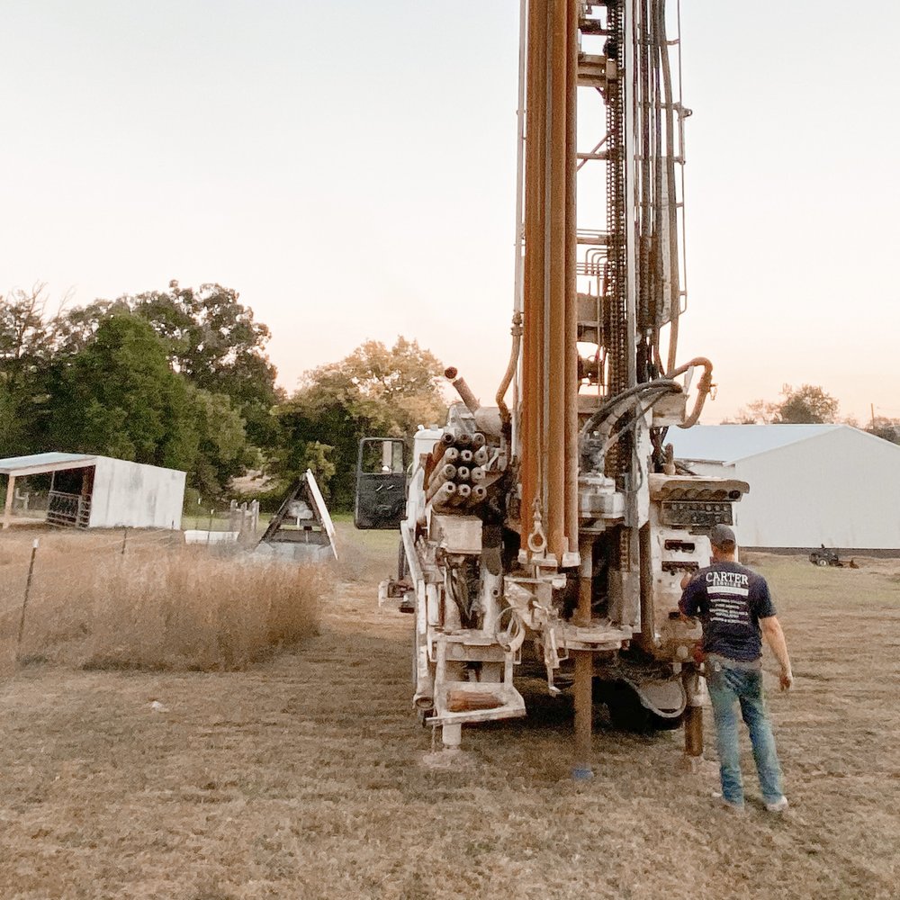 Water well drilling rig operating in Acton